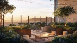Luxury rooftop terrace with fire pit seating and Golden Gate Bridge views overlooking the San Francisco Bay at sunset.
